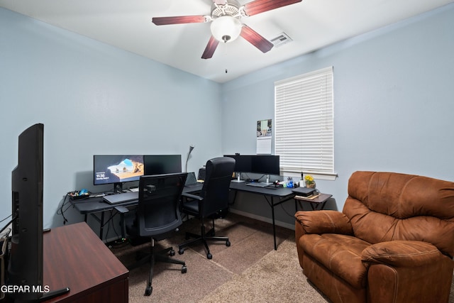 carpeted home office with visible vents, ceiling fan, and baseboards