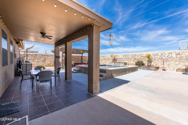 view of patio featuring ceiling fan, a fenced backyard, an outdoor hot tub, a pool, and outdoor dining space