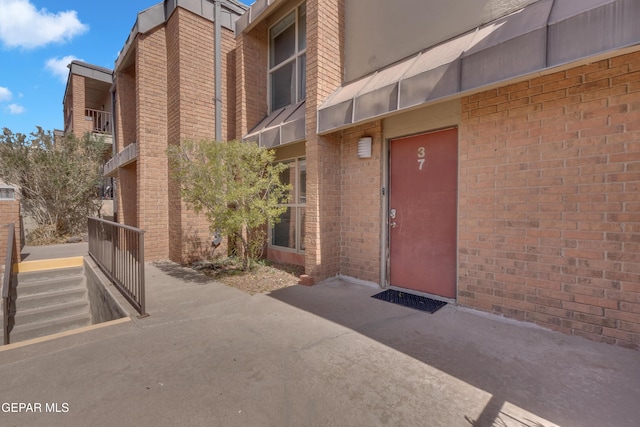 property entrance with brick siding