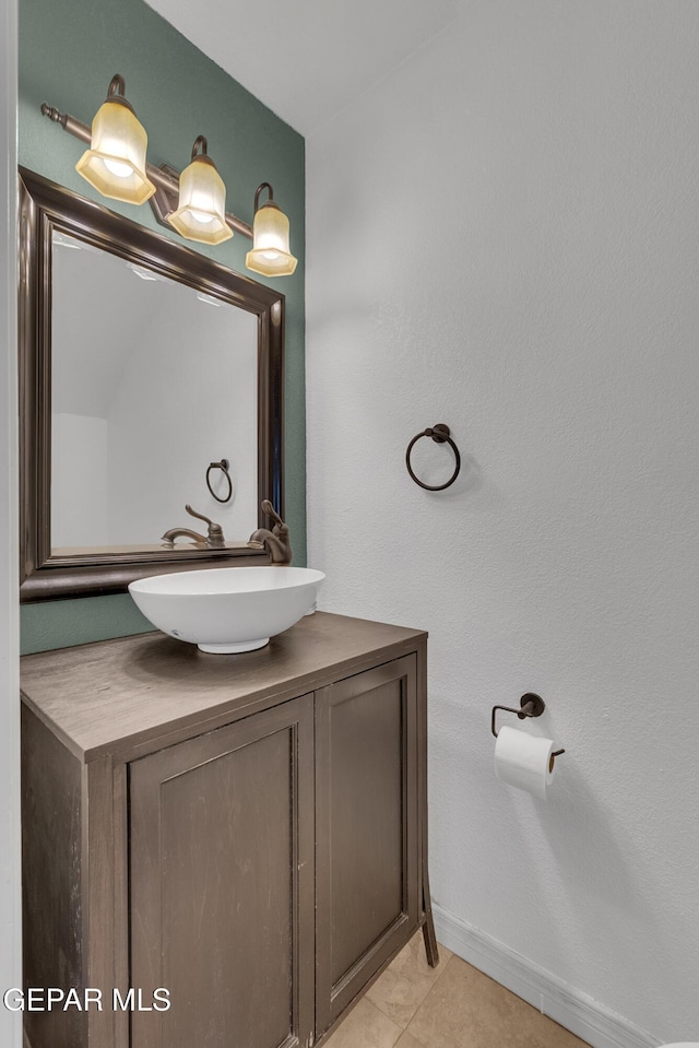 bathroom featuring tile patterned flooring, baseboards, and vanity