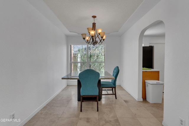 dining area with arched walkways, light tile patterned flooring, baseboards, and an inviting chandelier