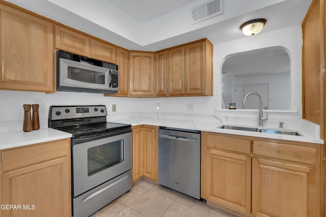 kitchen with light tile patterned floors, visible vents, appliances with stainless steel finishes, and a sink