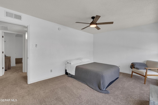 bedroom with baseboards, carpet, visible vents, and a textured ceiling