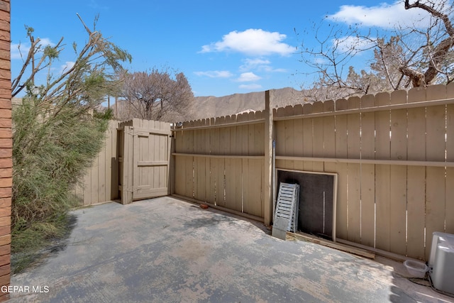 view of patio with a gate and fence