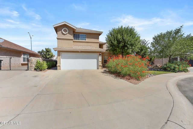 traditional home featuring concrete driveway, fence, an attached garage, and stucco siding