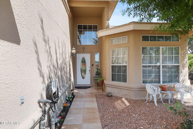 property entrance featuring stucco siding