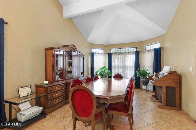 dining space featuring lofted ceiling with beams, light tile patterned floors, and baseboards