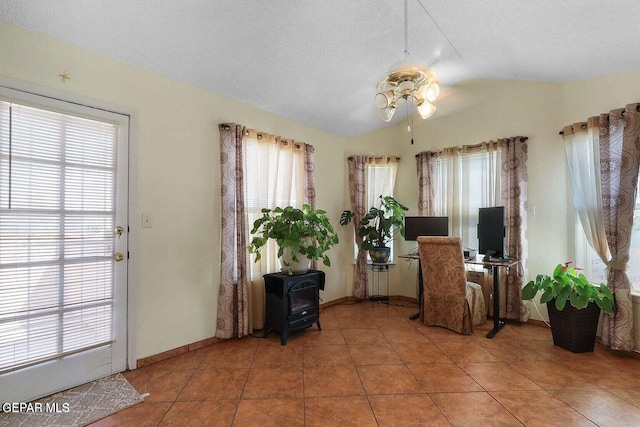 tiled office featuring ceiling fan, baseboards, vaulted ceiling, and a textured ceiling