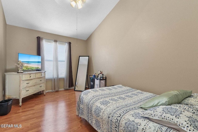 bedroom featuring vaulted ceiling and wood finished floors