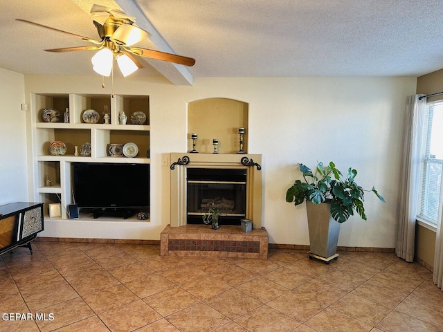 living area featuring a textured ceiling, baseboards, light tile patterned flooring, and built in features