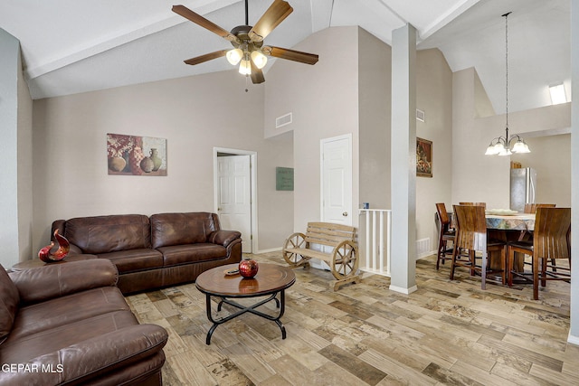 living area with lofted ceiling, wood finished floors, visible vents, and baseboards