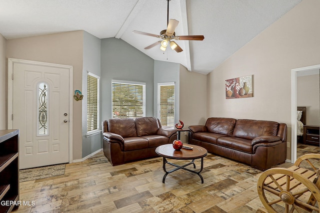 living area with light wood finished floors, baseboards, a ceiling fan, a textured ceiling, and high vaulted ceiling