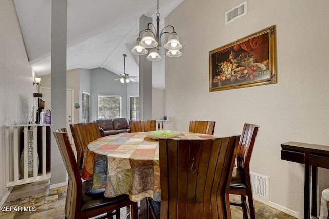 dining space featuring lofted ceiling, ceiling fan with notable chandelier, wood finished floors, and visible vents