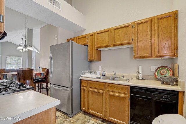 kitchen with light countertops, visible vents, a sink, a chandelier, and black appliances