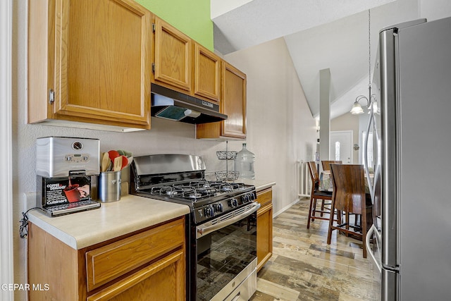 kitchen featuring lofted ceiling, stainless steel appliances, light countertops, under cabinet range hood, and a notable chandelier