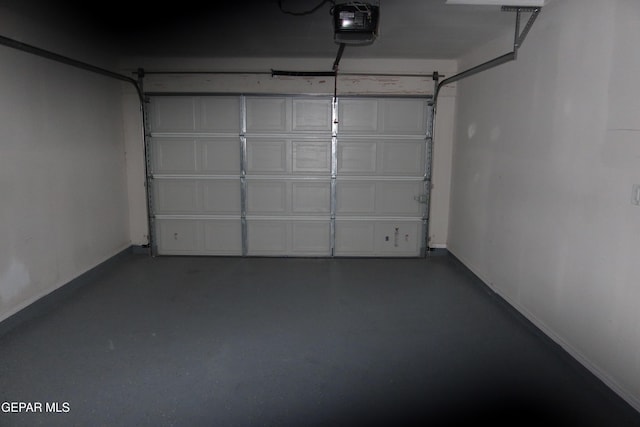 garage featuring baseboards and a garage door opener