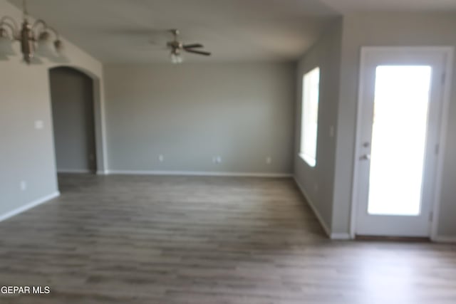 interior space with baseboards and wood finished floors