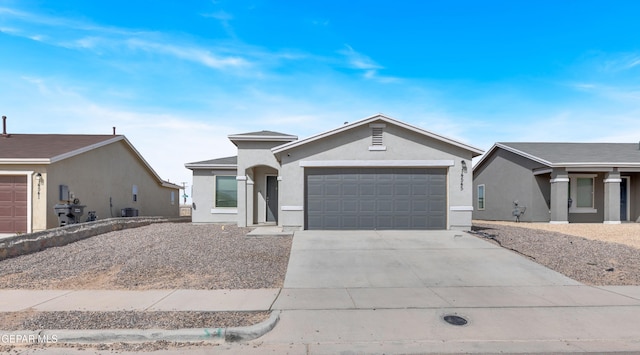 view of front of home with a garage, cooling unit, concrete driveway, and stucco siding