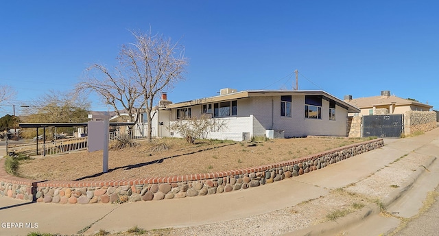 single story home with brick siding and fence