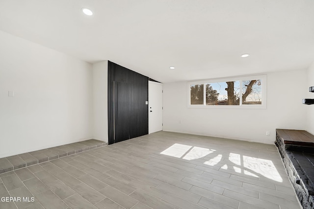 unfurnished living room featuring recessed lighting