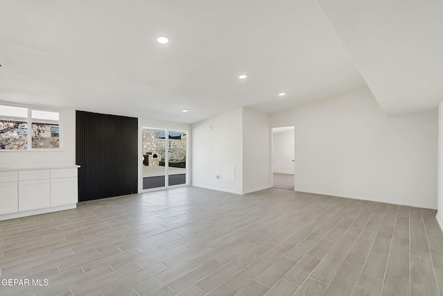 unfurnished living room featuring light wood-style floors, recessed lighting, and plenty of natural light