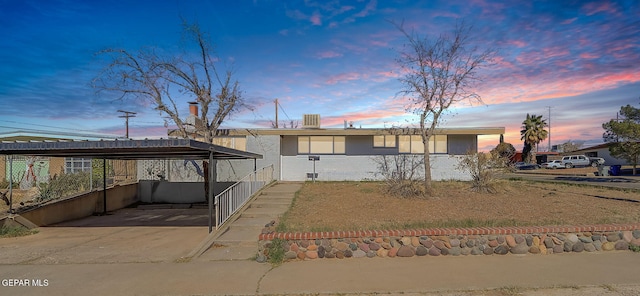 view of front of property with a detached carport and driveway