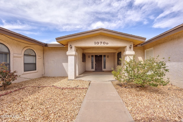 doorway to property with stucco siding