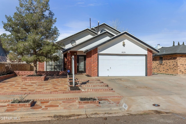 view of front facade with a garage, brick siding, concrete driveway, and fence