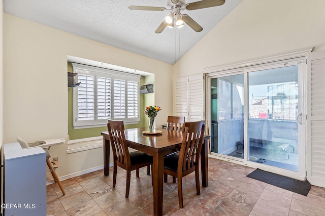 dining room featuring baseboards, ceiling fan, a textured ceiling, and lofted ceiling