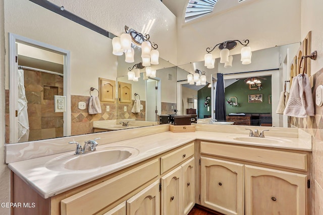 full bathroom featuring double vanity and a sink