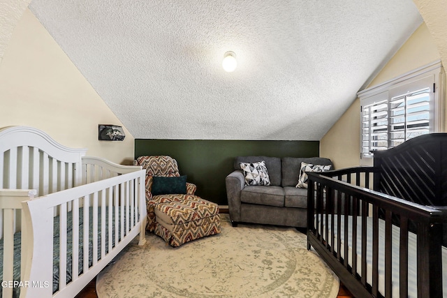 bedroom with a textured ceiling and lofted ceiling