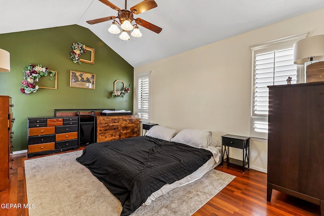 bedroom featuring baseboards, a ceiling fan, lofted ceiling, and wood finished floors