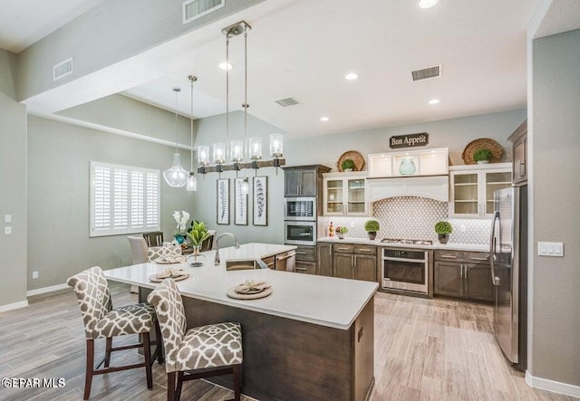 kitchen featuring light countertops, visible vents, appliances with stainless steel finishes, and a sink