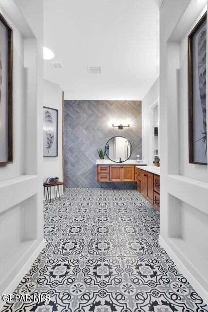 bathroom with vanity, tile patterned floors, and visible vents