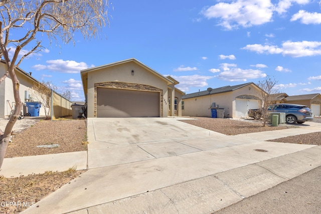 view of front facade with stucco siding, concrete driveway, and an attached garage