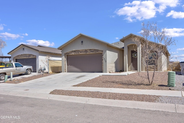 view of front facade featuring stucco siding, driveway, and an attached garage