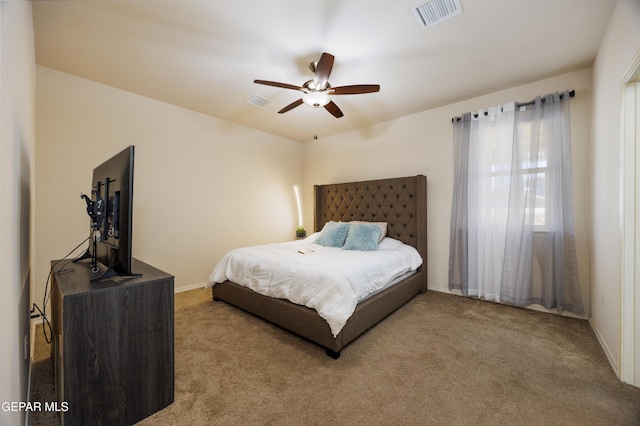 carpeted bedroom featuring visible vents and baseboards