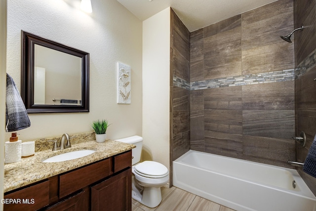 bathroom featuring bathing tub / shower combination, toilet, and vanity