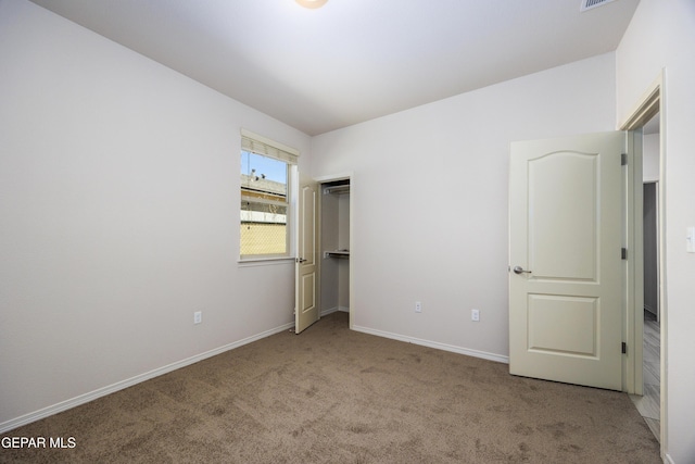 unfurnished bedroom with carpet flooring and baseboards