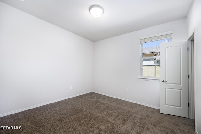 unfurnished room featuring baseboards and carpet floors