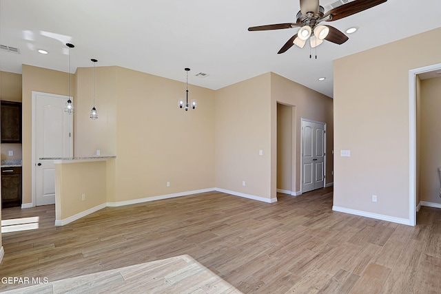 unfurnished living room with visible vents, light wood-style flooring, and baseboards