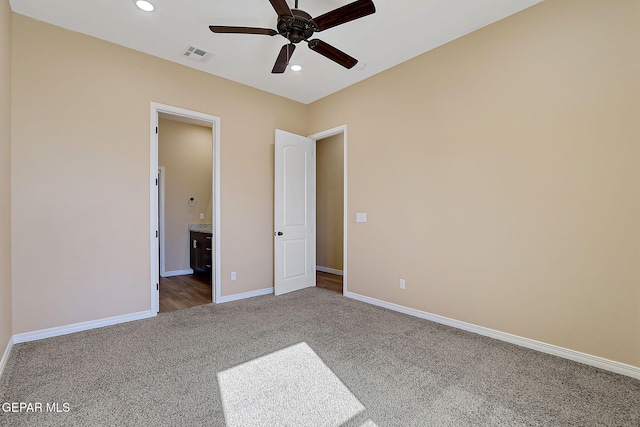 unfurnished bedroom with recessed lighting, visible vents, baseboards, carpet, and ensuite bath