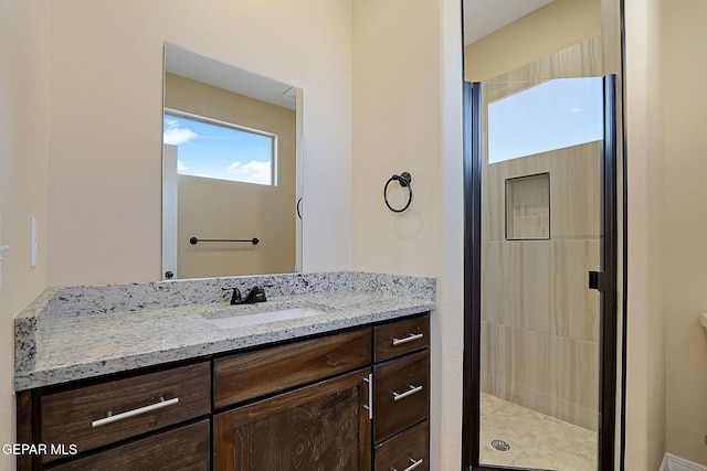 bathroom featuring a stall shower and vanity