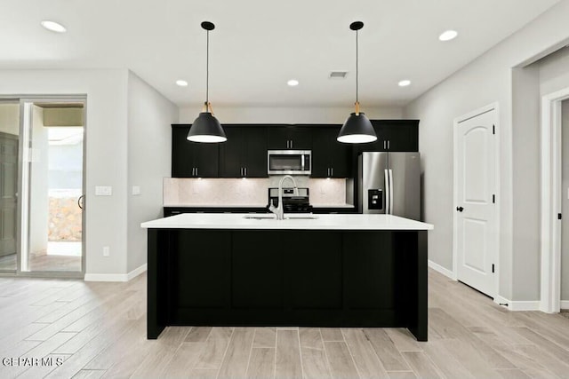 kitchen with light countertops, visible vents, dark cabinets, and appliances with stainless steel finishes