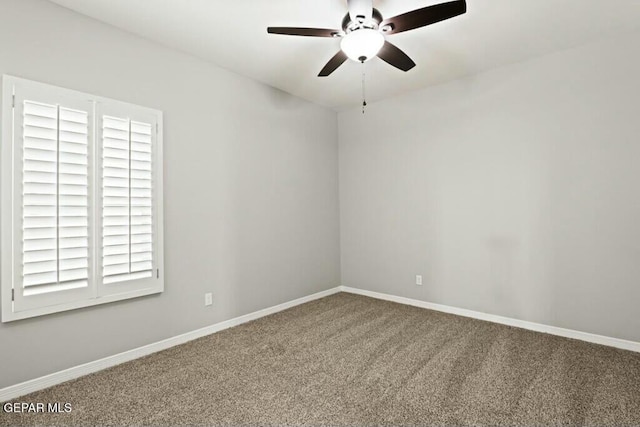 empty room with baseboards, carpet, and a ceiling fan