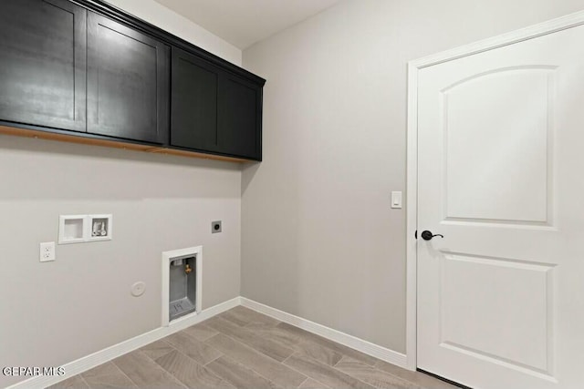 laundry area with hookup for a washing machine, baseboards, hookup for an electric dryer, cabinet space, and hookup for a gas dryer