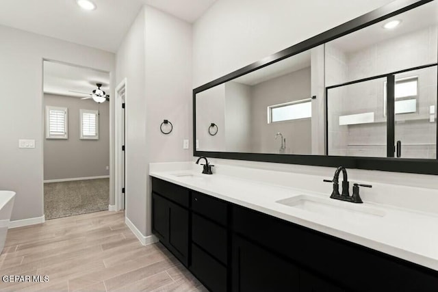 full bathroom with wood finished floors, recessed lighting, a ceiling fan, and a sink