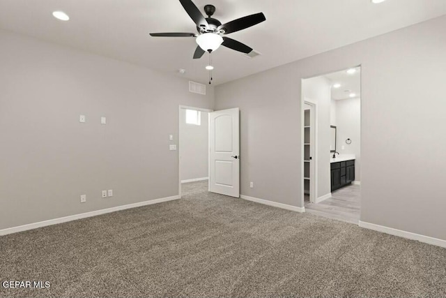 empty room featuring light carpet, visible vents, baseboards, and a ceiling fan