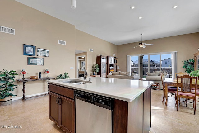 kitchen with visible vents, dishwasher, an island with sink, light countertops, and a sink