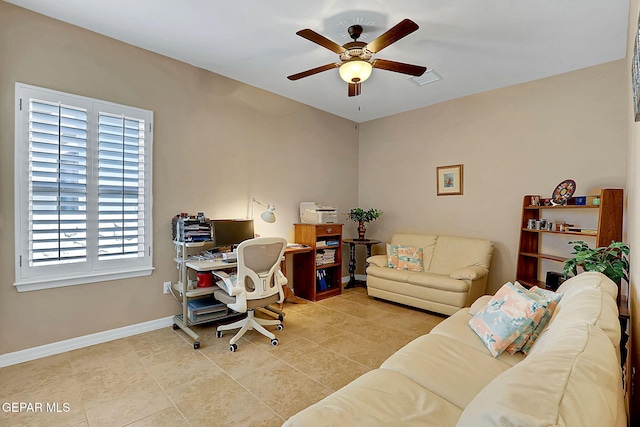 home office with a ceiling fan, tile patterned flooring, visible vents, and baseboards